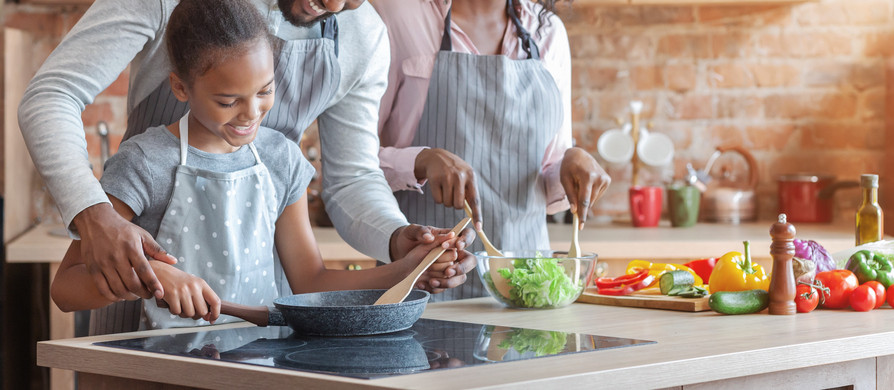 happy family cooking together in kitchen