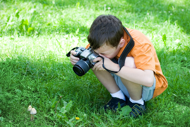 boy taking pictures outside